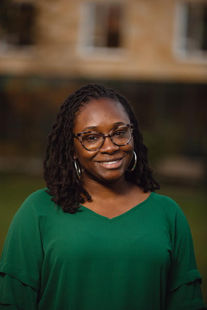 Headshot of Women in Green shirt