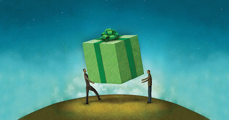 two people exhanging a wrapped gift box